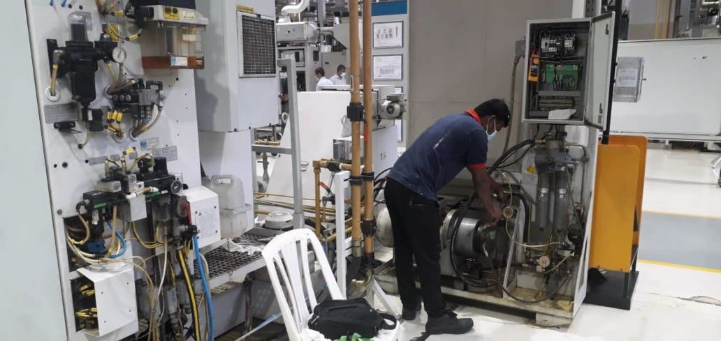 Yoganand technician maintaining a machine